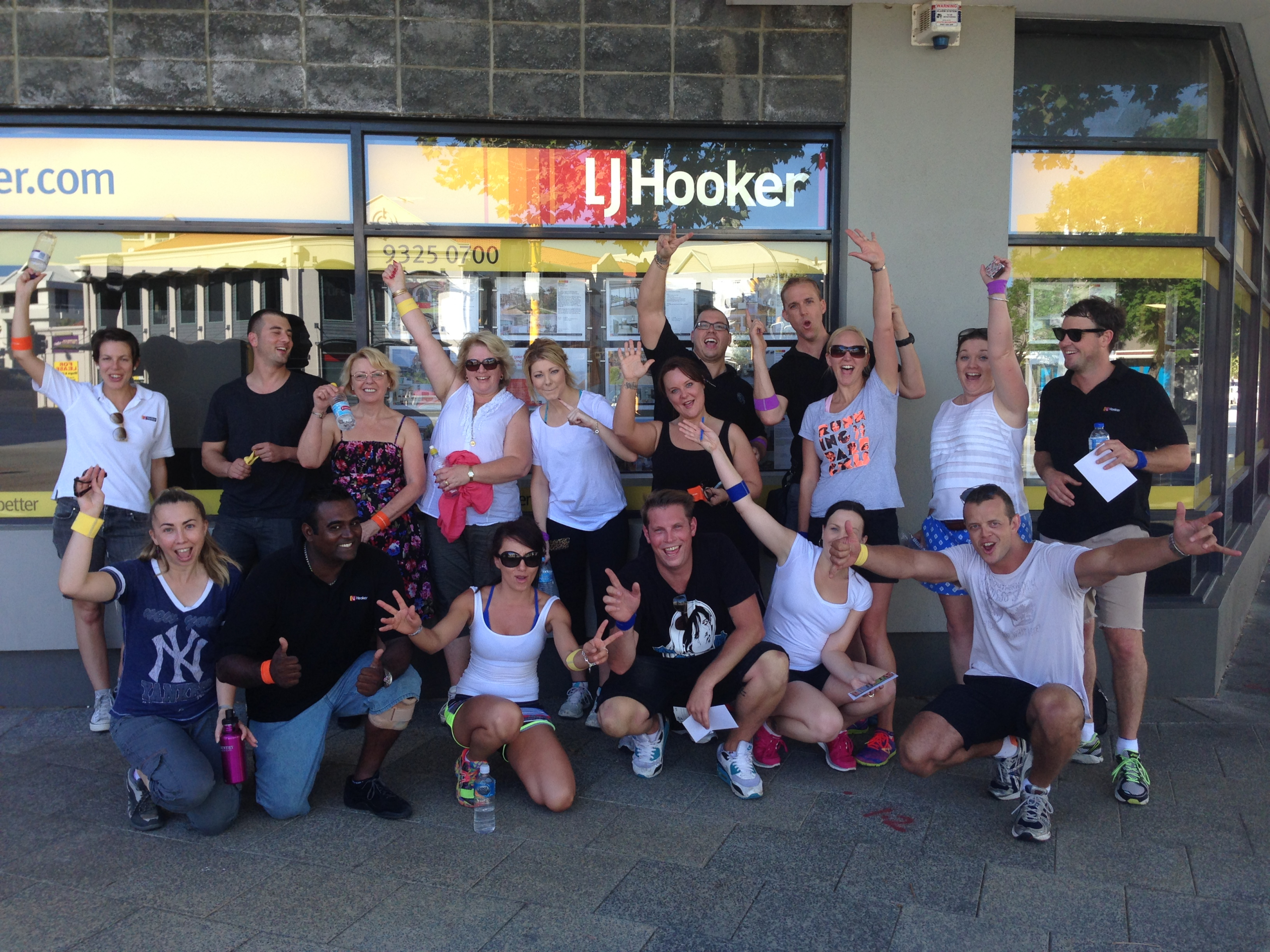Corporate team celebrating together after completing a scavenger hunt challenge on the Gold Coast.